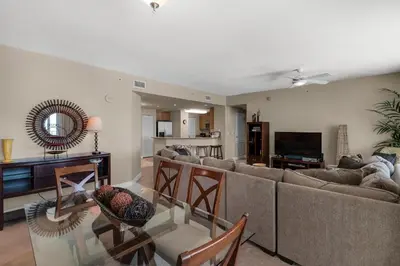 a living room with a couch and a table at Aqua 0602 in Panama City Beach