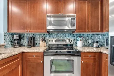 a kitchen with a stove and a microwave at Aqua 0709 in Panama City Beach