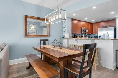 a kitchen and dining room with a wooden table and chairs at Aqua 0709 in Panama City Beach