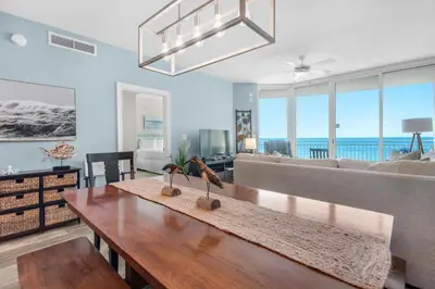 a living room with a table and a couch at Aqua 0709 in Panama City Beach