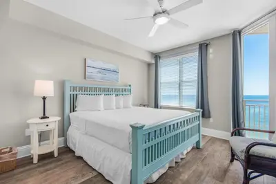 a bedroom with a bed and a large window at Aqua 0709 in Panama City Beach