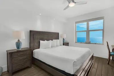a bedroom with a large bed and a window at Aqua 1802 in Panama City Beach
