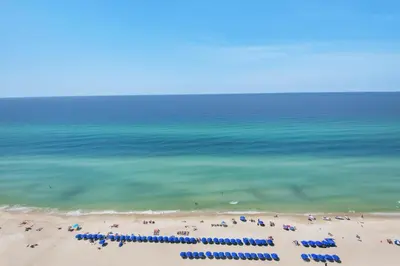 a view of a beach with many umbrellas and the ocean at Aqua 1802 in Panama City Beach