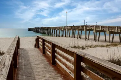 a wooden pathway to a pier on the beach at Aqua 1802 in Panama City Beach