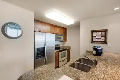 a kitchen with a stainless steel refrigerator and a sink at Aqua 1105 in Panama City Beach