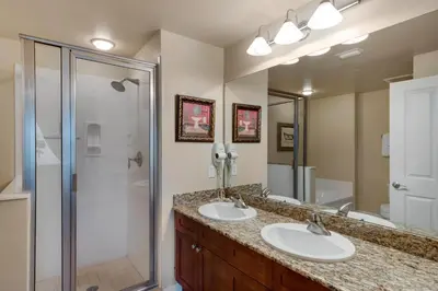 a bathroom with two sinks and a shower at Aqua 1105 in Panama City Beach