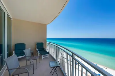 a balcony with chairs and a view of the ocean at Aqua 1105 in Panama City Beach