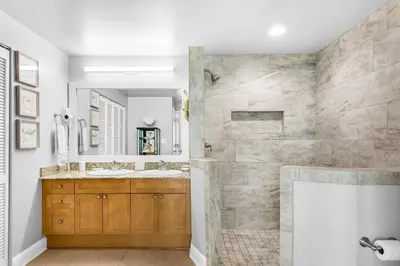 a bathroom with two sinks and a shower at Aqua 1609 in Panama City Beach