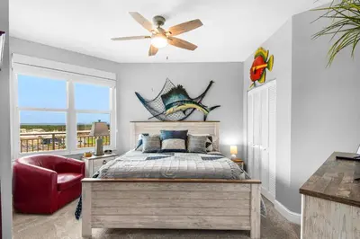 a bedroom with a bed and a ceiling fan at Aqua 1609 in Panama City Beach