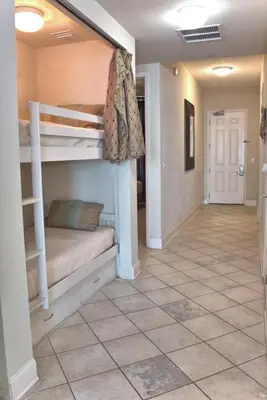 a hallway with two bunk beds in a house at Aqua 2305 in Panama City Beach