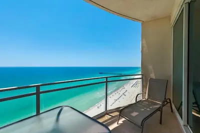 a balcony with a chair and the ocean at Aqua 2305 in Panama City Beach
