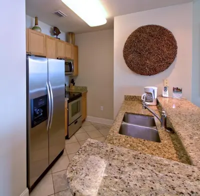 a kitchen with a stainless steel refrigerator and a sink at Aqua 2305 in Panama City Beach