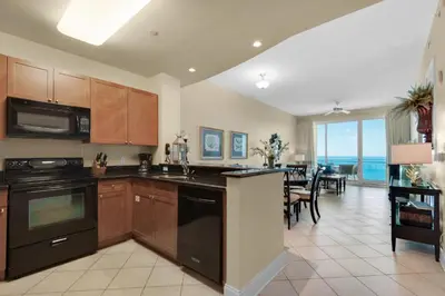 a kitchen and dining room with a view of the ocean at Aqua 2307 in Panama City Beach