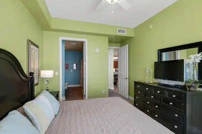 a bedroom with a bed and a flat screen tv at Aqua 2307 in Panama City Beach