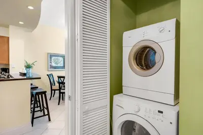 a laundry room with a washer and dryer at Aqua 2307 in Panama City Beach