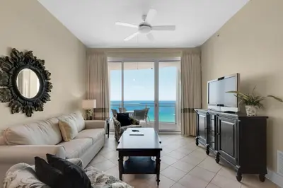 a living room with a couch and a flat screen tv at Aqua 2307 in Panama City Beach