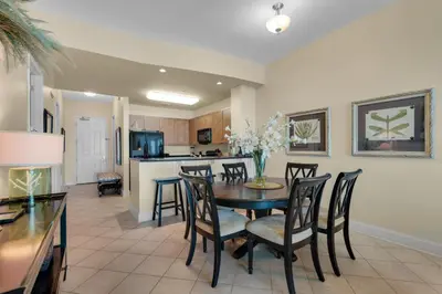 a dining room and kitchen with a table and chairs at Aqua 2307 in Panama City Beach