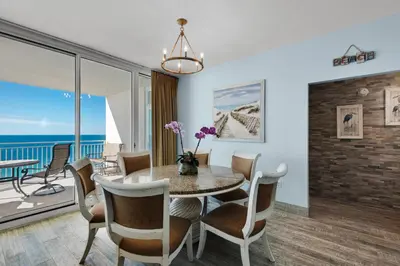 a dining room with a table and chairs at Aqua 1402 in Panama City Beach