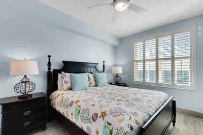 a bedroom with a bed and a window at Aqua 1402 in Panama City Beach