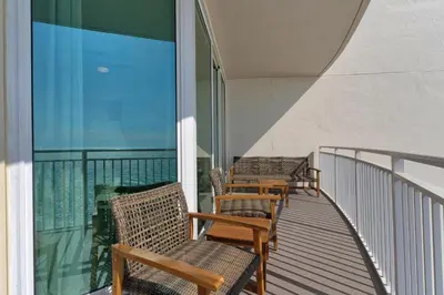 three chairs on a balcony with a view of the ocean at Aqua 1711 in Panama City Beach