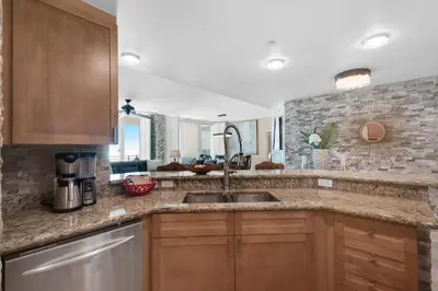 a kitchen with a sink and a counter top at Aqua 1602 in Panama City Beach