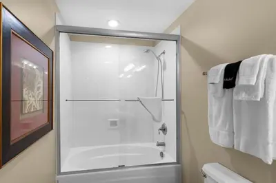 a shower with a glass door in a bathroom at Aqua 1602 in Panama City Beach