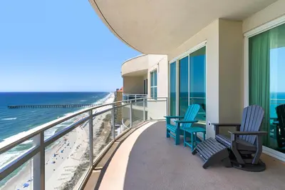 a balcony with chairs and a view of the beach at Aqua 2308 in Panama City Beach