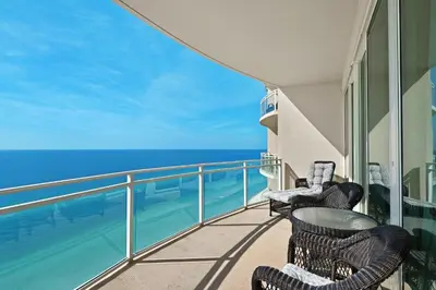 a balcony with chairs and a view of the ocean at Aqua 2201 in Panama City Beach