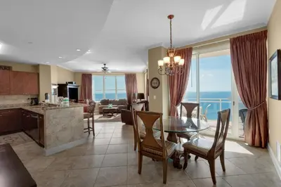 a kitchen and living room with a table and chairs at Aqua 2201 in Panama City Beach