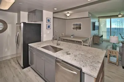 a kitchen with a sink and a counter top at Aqua 2111 in Panama City Beach