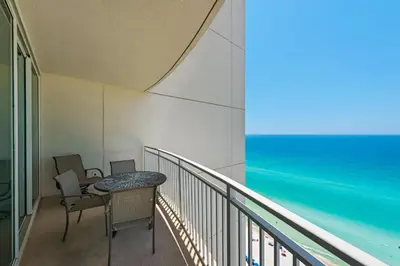 a balcony with a table and chairs and the ocean at Aqua 2111 in Panama City Beach
