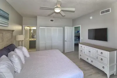 a bedroom with a bed and a flat screen tv at Aqua 2111 in Panama City Beach