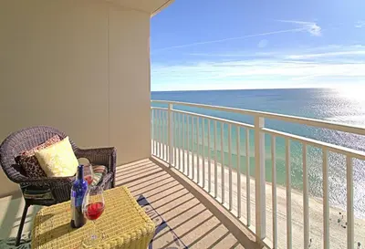 a balcony with a table and chairs and the ocean at Aqua 1507 in Panama City Beach