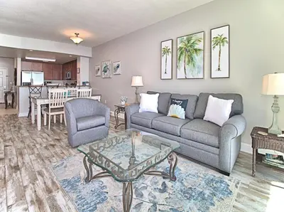 a living room with a couch and a table at Aqua 1507 in Panama City Beach