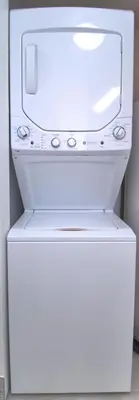 a white refrigerator with a microwave on top of it at Aqua 0506 in Panama City Beach