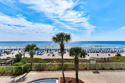 a view of a beach with palm trees and the ocean at Aqua 0208 in Panama City Beach
