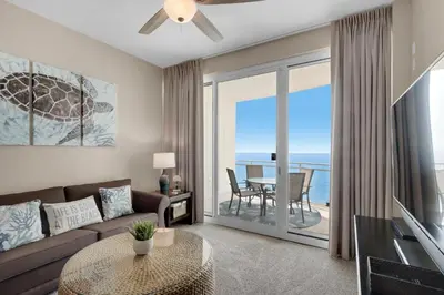 a living room with a couch and a table at Aqua 2207 in Panama City Beach