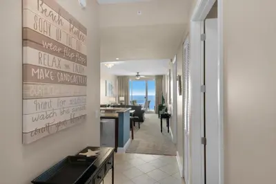a hallway with a living room and a dining room at Aqua 2207 in Panama City Beach