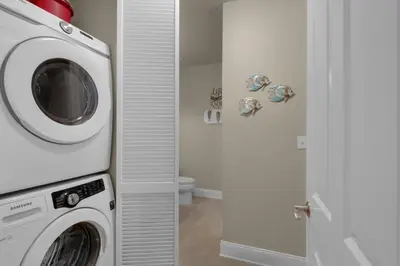 a white washer and dryer in a bathroom at Aqua 2207 in Panama City Beach