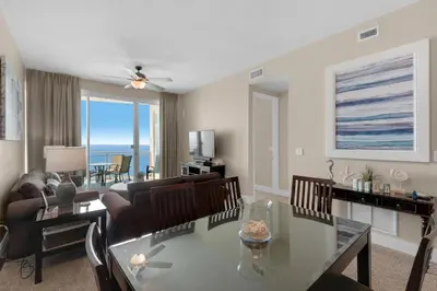 a living room with a glass table and chairs at Aqua 2207 in Panama City Beach