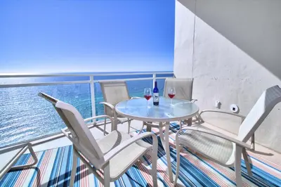 a balcony with a table and chairs on a ship at Aqua 2206 in Panama City Beach