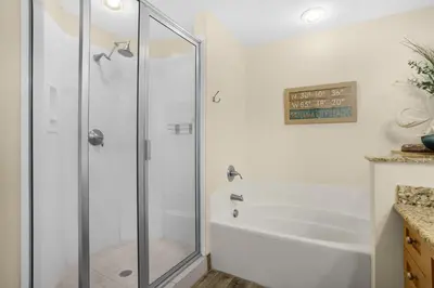 a shower with a glass door in a bathroom at Aqua 0610 in Panama City Beach