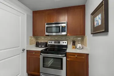 a kitchen with a stove and a microwave at Aqua 0302 in Panama City Beach