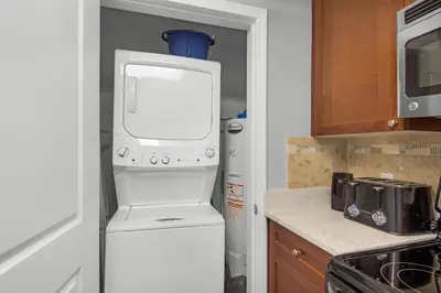 a small kitchen with a refrigerator and a microwave at Aqua 0302 in Panama City Beach