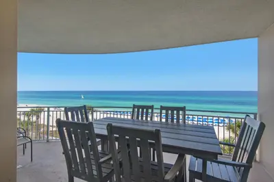 a table and chairs on a balcony with the beach at Aqua 0302 in Panama City Beach