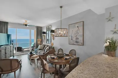 a living room with a table and chairs and a dining room at Aqua 2306 in Panama City Beach