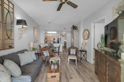 a living room with a couch and a table at Aqua 2306 in Panama City Beach