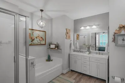 a white bathroom with a tub and a sink at Aqua 2306 in Panama City Beach