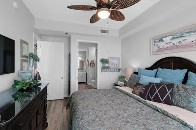 a bedroom with a bed and a ceiling fan at Aqua 2306 in Panama City Beach