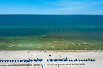 an overhead view of a beach with chairs and the ocean at Aqua 2306 in Panama City Beach